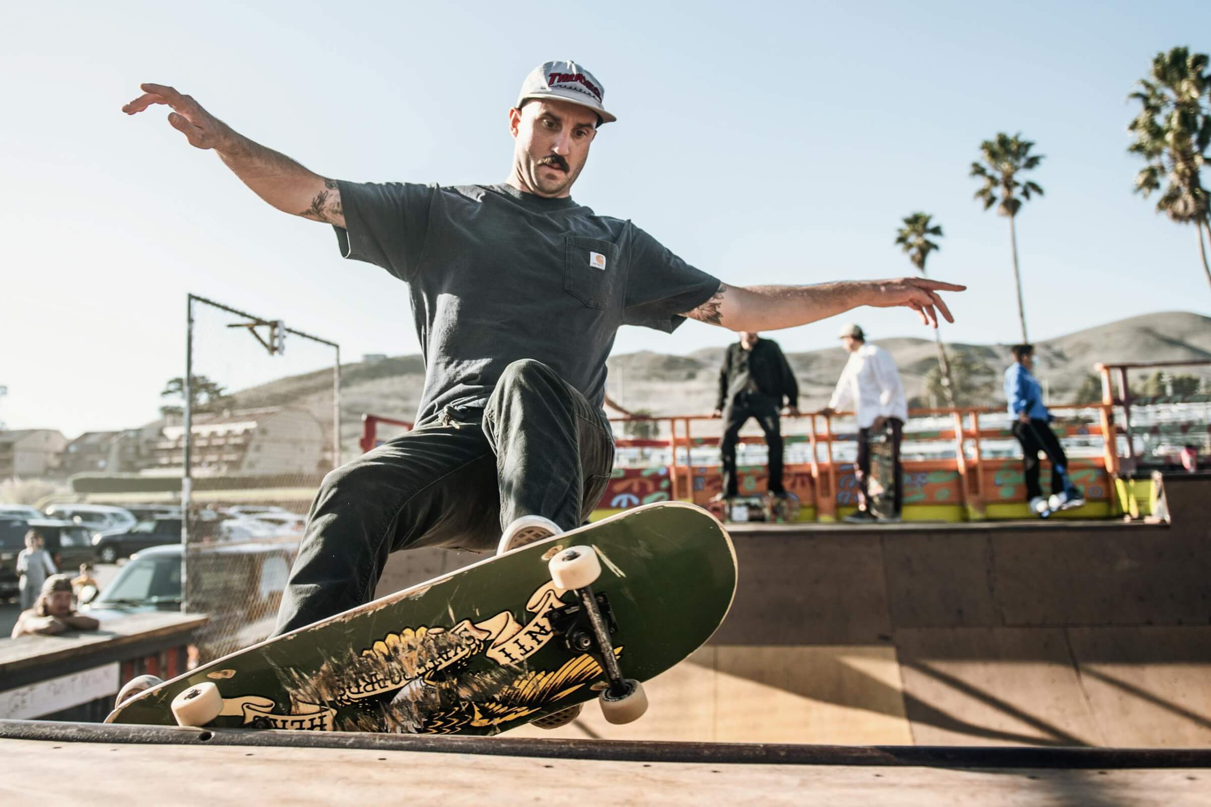 Skateboarder performing a trick at a skate park in Cayucos, CA.